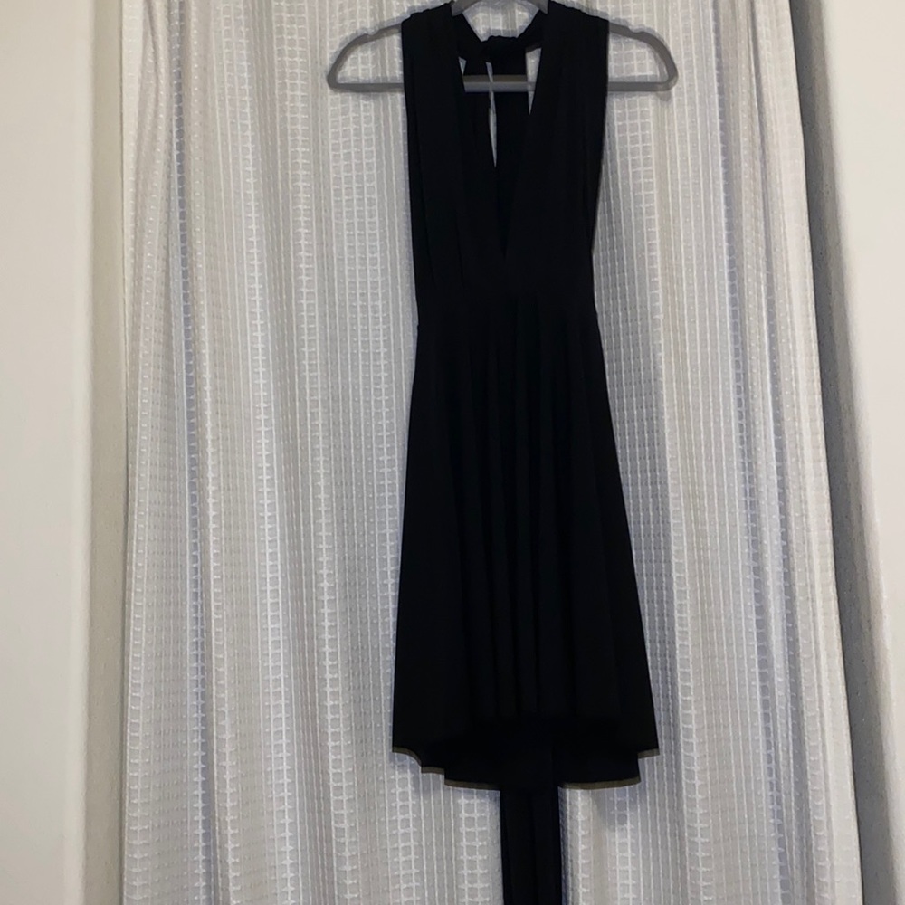 Cute and classy black dress. Open back and adjustable straps.